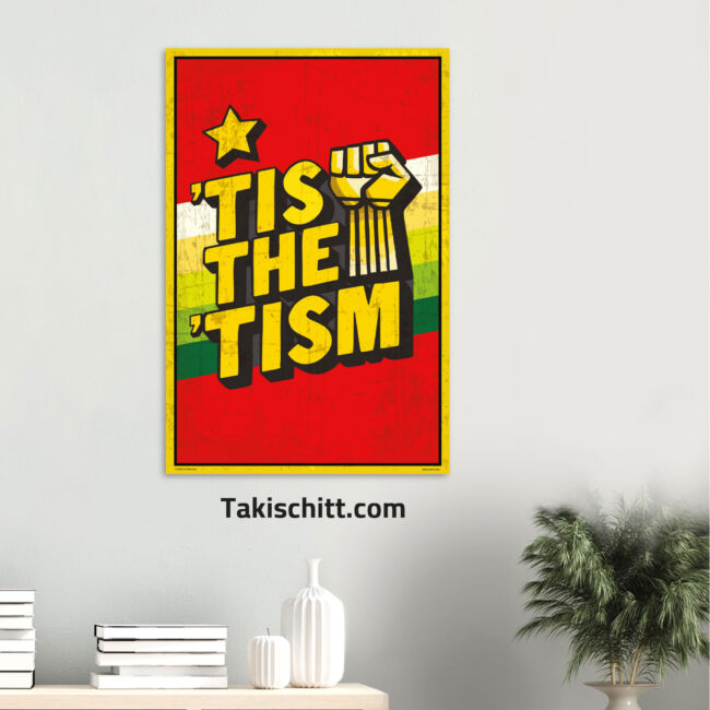 Tis The Tism poster being displayed on a light grey wall above a shelf, next to a plant