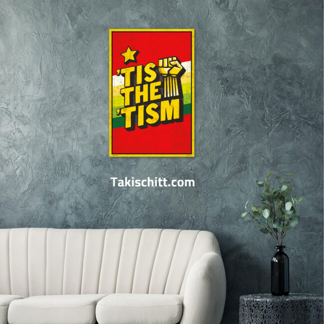 Tis The Tism poster being displayed on a dark green wall in a front room above a couch, next to a table