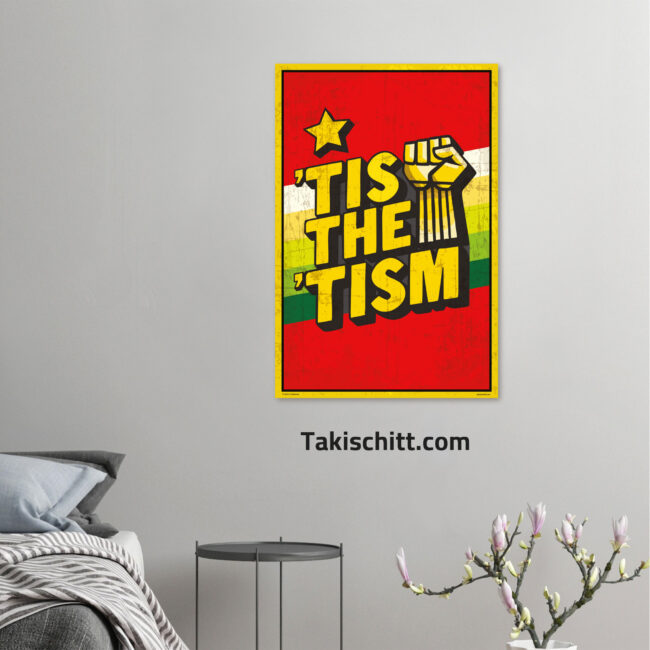 Tis The Tism poster being displayed on a grey wall above a grey bed and side table with a plant below